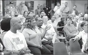  ?? Arkansas Democrat-Gazette/THOMAS METTHE ?? Community members listen to Little Rock police talk about crime statistics during a public forum Thursday night at Hall High School.