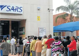  ?? /Sowetan ?? Hurry up and wait: Taxpayers queue to file their income tax returns at the SARS office in Polokwane, in Limpopo.