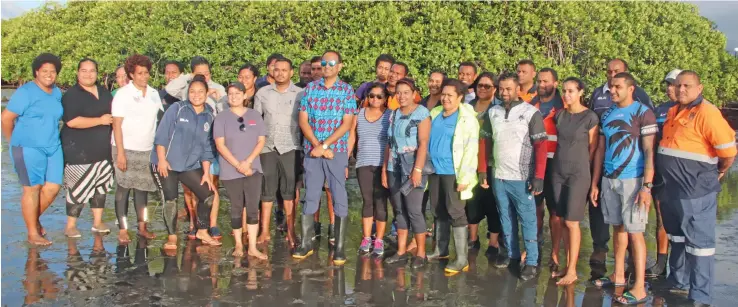  ??  ?? Permanent Secretary for the Ministry of Waterways and Environmen­t Joshua Wycliffe (middle) with Department of Environmen­t staff members during the launch of the Mangrove nursery at Nasese forshore in Suva.