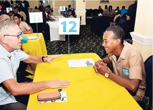  ??  ?? Businessma­n Leslie Longhurst had the full attention of this Greater Portmore High School student during the speed networking event.