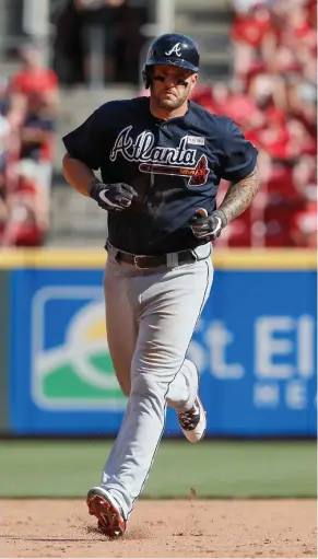  ?? AP) (Photo by John Minchillo, ?? Atlanta Braves’ Matt Adams runs the bases after hitting a grand slam off Cincinnati Reds starting pitcher Scott Feldman in the fifth inning on Saturday.