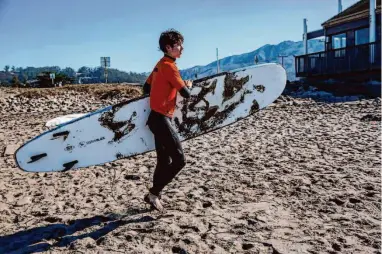  ?? Photos by Salgu Wissmath/The Chronicle ?? Axel Tostado, 15, a Surf Club student from S.F.’s Mission High School, hits the beach in Pacifica in February.