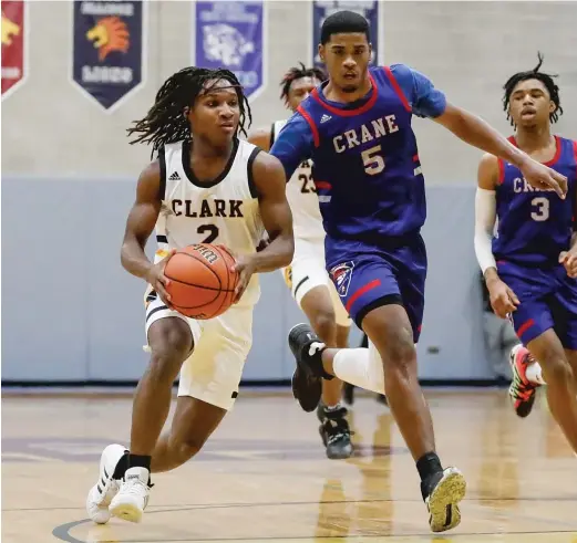  ?? KIRSTEN STICKNEY/FOR THE SUN-TIMES ?? Clark’s Darrius Perryman sprints past Crane’s Jimarius Sneed in the final Friday of the Class 2A Christ the King Regional.