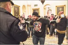  ?? Associated Press ?? Supporters of President Donald Trump are confronted by Capitol Police officers outside the Senate Chamber on Wednesday.