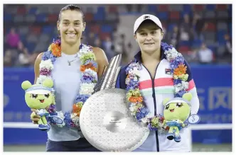  ??  ?? Tournament winner Caroline Garcia of France, left, and second place Ashleigh Barty of Australia after the women's singles final match at the WTA Wuhan Open tennis tournament in Wuhan on Saturday. (AFP)