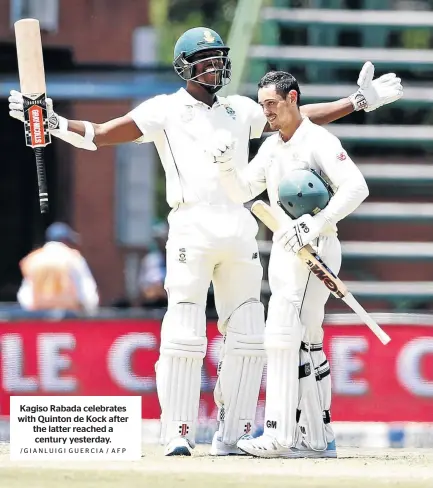  ?? /GIANLUIGI GUERCIA / AFP ?? Kagiso Rabada celebrates with Quinton de Kock after the latter reached a century yesterday.