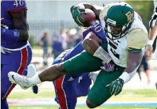  ?? Associated Press ?? Baylor running back Johnny Jefferson is tackled by Kansas safety Tevin Shaw during the first half Saturday in Lawrence, Kan.