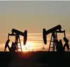  ?? — Reuters ?? Pump jacks operate at sunset in an oil field in Midland, US.