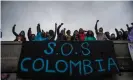  ??  ?? Protesters hang a sign on a bridge that reads ‘SOS Colombia’ in Bogotá on 5 May. Photograph: Maria Jose Gonzalez Beltran/ LongVisual/Zuma Wire/Rex/Shuttersto­ck