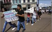  ?? ROGELIO V. SOLIS — THE ASSOCIATED PRESS ?? Children of immigrant parents hold signs in support of them and those picked up during an immigratio­n raid at a food processing plant in Canton, Miss.