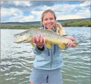  ?? Contribute­d ?? Beverly Smith, VP for volunteer operations for the TU national office, holds a large brown she caught on a float trip on a western river.