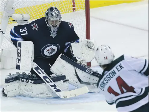  ?? KEVIN KING/WINNIPEG SUN ?? Jets goaltender Connor Hellebuyck stops a shot from Minnesota Wild centre Joel Eriksson Ek during Game 1 last night.