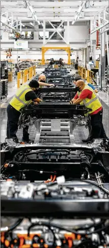  ?? LYNDON FRENCH/THE NEW YORK TIMES ?? Rivian (assembling cars at one of its plants in Normal, Ill.) wants to sell directly to customers because “we know these vehicles best,” says Jim Chen, vice president of public policy for Plymouth, Michigan-based company.
Rep. Chuck Martin, R-alpharetta, who pushed legislatio­n to let Tesla sell cars without going through local dealers, is sponsoring a similar bill.