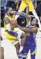  ?? John Locher Associated Press ?? LeBRON JAMES, left, is fouled by Golden State’s Andre Iguodala during an exhibition game.