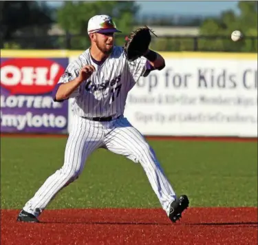  ?? RANDY MEYERS — THE MORNING JOURNAL ?? Crushers shortstop Trevor Archenbach looks at a high grounder and is able to make the catch and throw for the out.