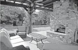  ?? [PHOTOS BY BRYAN TERRY, THE OKLAHOMAN] ?? An outdoor living space under a pergola is shown at Jamestown Condominiu­ms, west of May Avenue and north of NW 63.