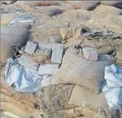  ?? HT PHOTOS ?? Wheat bags lying in the open on Assandh road at Jundla town of Karnal district.