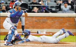  ?? Frank Franklin II ?? The Associated Press Javier Baez steals home as Mets catcher Kevin Plawecki awaits a throw in the seventh inning of the Cubs’ 2-0 win Sunday at Citi Field.