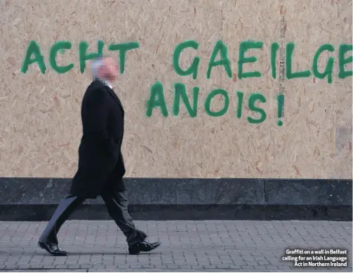  ??  ?? Graffiti on a wall in Belfast calling for an Irish LanguageAc­t in Northern Ireland