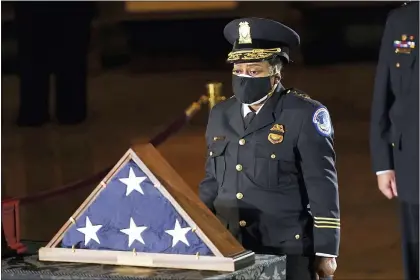  ?? ERIN SCHAFF — THE NEW YORK TIMES VIA AP ?? In this Feb. 2, 2021file photo, acting U.S. Capitol Police Chief Yogananda Pittman pays respects to U.S. Capitol Police officer Brian Sicknick in the Capitol Rotunda in Washington.