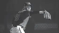  ?? TAYLOR JACKSON/ARIZONA DIAMONDBAC­KS ?? Diamondbac­ks pitcher Alex Young throws on Wednesday, the first workout for pitchers and catchers this spring.