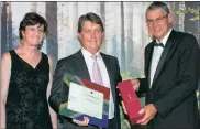  ??  ?? Mike Estment, the chairman of NFB (centre), collected the Raging Bull for the Best South African Multi-asset Equity Fund on a risk-adjusted basis, which was awarded to the NFB Ci Cautious Fund of Funds. It was presented by Laura du Preez, the editor of...