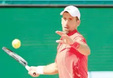  ?? — AFP ?? Serbia’s Novak Djokovic plays a forehand return to Italy’s Lorenzo Musetti during their Monte Carlo ATP Masters Series Round of 16 match.