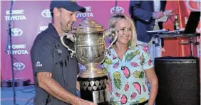  ?? Picture: MARK CARRELS ?? TITLE HOLDERS: Cuylervill­e captain Brandon Handley receives the Pineapple Cricket Tournament trophy from tournament sponsor, Kowie Toyota dealer principal, Noleen Acton, at the prize-giving ceremony at the Port Alfred Country Club last year.