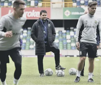  ??  ?? 2 Brendan Rodgers donates a shirt to the Northern Ireland Children’s Hospice, with Michelle Neill and her daughter, Aimee. Above: Linfield coach David Healy supervises as his side train at Windsor Park yesterday. Right: Linfield striker Andrew Waterworth on the ball