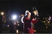  ?? PETER MORRISON — THE ASSOCIATED PRESS ?? People participat­e in a candleligh­t pilgrimage which makes its way past an ancient well associated with St. Brigid to the Solas Bhride Center in Kildare, Ireland, on Tuesday.