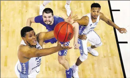  ?? ANDY LYONS / GETTY IMAGES ?? Kennedy Meeks, grabbing a rebound against Kentucky, powers a Tar Heels team that topped the nation in offensive rebounds. The Tar Heels got 17 second-chance points against the Wildcats.