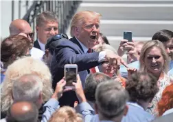  ?? CHIP SOMODEVILL­A/GETTY IMAGES ?? President Donald Trump talks with invited guests at his “Made In America” product showcase Monday at the White House.