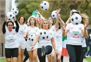  ?? ISABEL INFANTES/GETTY-AFP ?? Whistleblo­wers: British-Iranian women protest Saturday near the Houses of Parliament in London, ahead of Iran’s match against England on Monday at the World Cup in Qatar. The women were calling on people in Iran and around the world to protest at the start of every match played by Iran at the tourney by blowing a whistle for one minute.