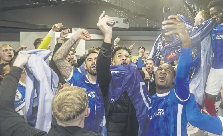  ?? Picture: Jason Brown/prosportsi­mages ?? Smells like team spirit – Pompey’s tight-knit squad celebrate the League One title success after victory over Barnsley