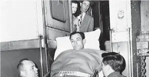  ?? AP ?? Golfer Ben Hogan is ushered from train in which he made his trip back home to Fort Worth, Texas, on April 1, 1949.