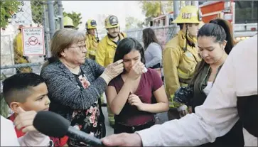  ?? Damian Dovarganes Associated Press ?? MARIANNA TORRES, 11, center, cries as she evacuates Park Avenue Elementary in Cudahy after the jet fuel fell Tuesday. “Our entire community has been adversely impacted,” said City Council Member Jack Guerrero.