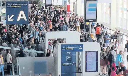  ??  ?? Checkpoint chaos...scores of passengers are forced to join the long passport queues at Orly Airport in Paris