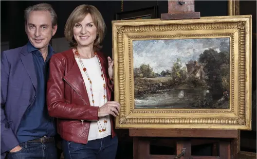  ??  ?? No fake: BBC presenters Philip Mould and Fiona Bruce with the £2 million painting Mr Mould sold in the 1990s for £35,000