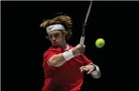  ?? AP Photo/Bernat Armangue ?? ■ Russia’s Andrey Rublev returns the ball to Croatia’s Borna Gojo during their Davis Cup match Monday in Madrid, Spain.