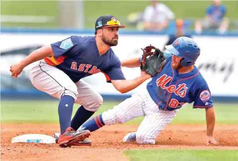  ?? Jeff Roberson/Associated Press ?? ■ New York Mets' Patrick Biondi, right, is safe at second for a stolen base as Houston Astros shortstop Jack Mayfield waits for the throw during the third inning of an exhibition spring training baseball game Tuesday in Port St. Lucie, Fla.