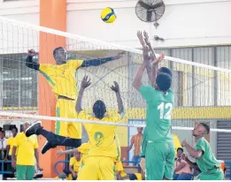  ?? ALLEN/PHOTOGRAPH­ER PHOTOS BY IAN ?? Lovelet Blake (left) from St Jago High School, jumped high to spike a set from Ajani Gordon (centre) as Frome Technical High School’s Oral Davis (second right) tries to execute a block during the ISSA Rural Area High Schools Volleyball final at G.C. Foster College yesterday.