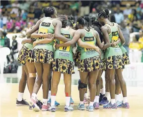  ?? FILE ?? Members of Jamaica’s national senior women’s netball team, the Sunshine Girls, huddle during a match against England in the Sunshine Series last year at the National Indoor Sports Centre.