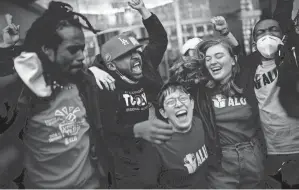  ?? EDUARDO MUNOZ ALVAREZ/AP FILE ?? Staten Island, N.y.-based Amazon distributi­on center union members celebrate after voting results come in on Friday.