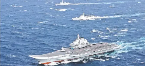  ?? — Reuters photo ?? Files photo shows China’s Liaoning aircraft carrier with accompanyi­ng fleet conducts a drill in an area of South China Sea, in this undated photo.