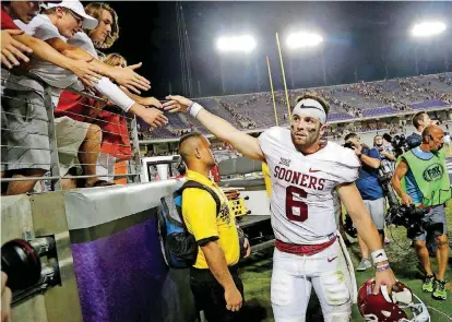  ?? TERRY, THE OKLAHOMAN] [PHOTO BY BRYAN ?? OU quarterbac­k Baker Mayfield celebrates with fans after the Sooners’ 52-46 victory over TCU last year in Fort Worth.