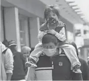  ?? DOLORES OCHOA/AP ?? Despite internet claims that wearing a mask could lower oxygen levels and cause neurologic­al damage, doctors insist they’re safe for adults and children older than 2.