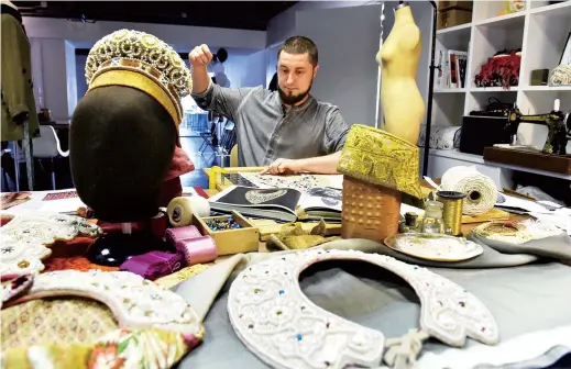  ??  ?? Designer Yukhann Nikadimus makes a Russian traditiona­l kokoshnik headdress at a workshop in Moscow. — AFP