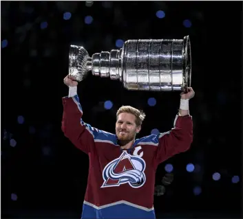  ?? AARON ONTIVEROZ — THE DENVER POST ?? Gabriel Landeskog, captain of the Colorado Avalanche, hoists the Stanley Cup during a championsh­ip celebratio­n before the first period against the Chicago Blackhawks at Ball Arena in Denver on Oct. 12.
