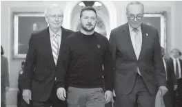  ?? DREW ANGERER Getty Images/TNS ?? Ukrainian President Volodymyr Zelenskyy, center, walks with Senate Minority Leader Mitch McConnell, R-Ky., left, and Senate Majority Leader Charles Schumer, D-N.Y., at the U.S. Capitol on Tuesday in Washington. ‘We’re in ... a fight for freedom,’ Zelenskyy says.