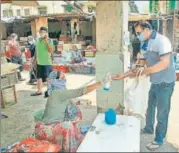  ?? ANI ?? A man uses hand sanitizer at a fish market during the lockdown n triggered by the coronaviru­s disease, in Mumbai on Friday.